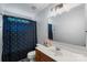 Well-maintained bathroom with a vanity, toilet, and a shower with a patterned curtain, offering functionality and style at 4006 Centerview Dr, Indian Trail, NC 28079
