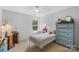 Bright bedroom with a vintage dresser, cozy chair, and a soft bed, creating a serene and inviting atmosphere at 4006 Centerview Dr, Indian Trail, NC 28079
