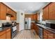 Functional kitchen with stainless appliances, wood cabinets, and granite countertops at 4006 Centerview Dr, Indian Trail, NC 28079