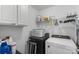 Efficient laundry area with a washer, dryer, overhead storage, and practical accessories for seamless chores at 4006 Centerview Dr, Indian Trail, NC 28079