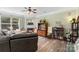 Bright living room features a fireplace, large window, ceiling fan, and wood-look floors at 4006 Centerview Dr, Indian Trail, NC 28079