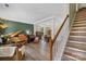 Open-concept living room boasts natural light, complemented by hardwood floors and elegant staircase at 4006 Centerview Dr, Indian Trail, NC 28079