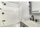 Bright bathroom featuring a shower-tub combo, vanity with marble countertop, and built-in storage at 403 Weaver St, Cherryville, NC 28021