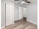 Neutral bedroom featuring a ceiling fan, updated flooring, and ample closet space at 403 Weaver St, Cherryville, NC 28021