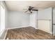 Neutral bedroom featuring a ceiling fan, updated flooring, and a decorative brick fireplace at 403 Weaver St, Cherryville, NC 28021