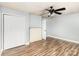 Neutral bedroom featuring a ceiling fan, updated flooring, and a decorative brick fireplace at 403 Weaver St, Cherryville, NC 28021