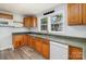 Functional kitchen featuring classic wood cabinets, laminate countertops, and a stainless steel sink with a view at 403 Weaver St, Cherryville, NC 28021
