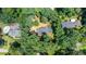 An aerial view of the neighborhood with a house surrounded by lush trees and well-maintained landscapes at 411 Saint Andrews Rd, Statesville, NC 28625