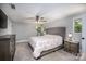 A bedroom with a bed, two windows, carpeted floors, a ceiling fan and a chest of drawers at 411 Saint Andrews Rd, Statesville, NC 28625