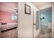 One of two bedroom views from the hallway, which features colorful decor, carpeting, and a ceiling fan at 411 Saint Andrews Rd, Statesville, NC 28625