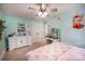 The bedroom features light blue walls, a ceiling fan with lights, and a dressing area with a vanity at 411 Saint Andrews Rd, Statesville, NC 28625