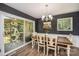 A dining room with hardwood floors, white wainscoting and sliding doors that lead to the backyard at 411 Saint Andrews Rd, Statesville, NC 28625