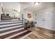 Charming entryway with hardwood floors, a console table, and stairs leading to an upper level living space at 411 Saint Andrews Rd, Statesville, NC 28625