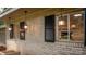 Brick exterior with hanging lanterns and dark shutters adds charm and character to the home's facade at 411 Saint Andrews Rd, Statesville, NC 28625