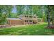 Charming two-story home with brick accents, a landscaped yard, and a welcoming front porch at 411 Saint Andrews Rd, Statesville, NC 28625