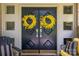Inviting front doors adorned with yellow wreaths, complemented by stylish seating, creates a warm welcome at 411 Saint Andrews Rd, Statesville, NC 28625