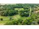Scenic aerial view of the neighborhood with a golf course surrounded by lush greenery and trees at 411 Saint Andrews Rd, Statesville, NC 28625