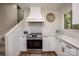 A kitchen with white cabinets, marble countertops, subway tile backsplash and stainless steel appliances at 411 Saint Andrews Rd, Statesville, NC 28625
