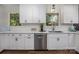The kitchen features white cabinets, marble countertops and stainless steel appliances at 411 Saint Andrews Rd, Statesville, NC 28625