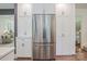 A modern, stainless steel refrigerator in a kitchen with white cabinets and marble countertops at 411 Saint Andrews Rd, Statesville, NC 28625