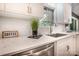 Close-up of a bright kitchen featuring marble countertops and stainless steel appliances at 411 Saint Andrews Rd, Statesville, NC 28625