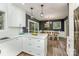A kitchen island with white cabinets, drawers and marble countertops opens to the dining room at 411 Saint Andrews Rd, Statesville, NC 28625