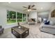 Cozy living room featuring a brick fireplace, neutral furniture, and large windows at 411 Saint Andrews Rd, Statesville, NC 28625