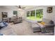Airy living room with large windows, a ceiling fan, and comfortable seating at 411 Saint Andrews Rd, Statesville, NC 28625