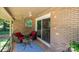 This brick patio features cozy seating with red cushions, string lights, and a black-and-white patterned rug at 411 Saint Andrews Rd, Statesville, NC 28625