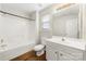 Bright bathroom with a shower-tub combo, white vanity, and neutral wall color at 4510 Glenlea Commons Dr, Charlotte, NC 28216