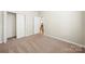 Comfortable bedroom with neutral tones, closet and window at 4510 Glenlea Commons Dr, Charlotte, NC 28216
