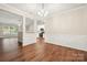 Spacious dining room with hardwood flooring and view to the kitchen, perfect for entertaining at 4510 Glenlea Commons Dr, Charlotte, NC 28216