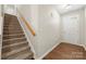 Hallway featuring staircase with carpet runner and wood railing at 4510 Glenlea Commons Dr, Charlotte, NC 28216