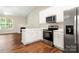Well-lit kitchen features white cabinets and stainless steel appliances at 4510 Glenlea Commons Dr, Charlotte, NC 28216