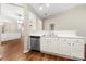 Open kitchen features a stainless steel dishwasher and white cabinets at 4510 Glenlea Commons Dr, Charlotte, NC 28216