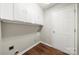 Laundry room features overhead storage and wood-look floors at 4510 Glenlea Commons Dr, Charlotte, NC 28216