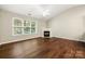Bright living room includes a fireplace, ceiling fan, and hardwood floors at 4510 Glenlea Commons Dr, Charlotte, NC 28216