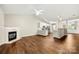 Open-concept living space with a cozy fireplace and an adjacent kitchen area at 4510 Glenlea Commons Dr, Charlotte, NC 28216