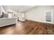 Bright living room features hardwood floors and an open layout with kitchen at 4510 Glenlea Commons Dr, Charlotte, NC 28216
