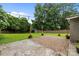 A backyard featuring a brick patio, a wooden fence, string lights, and a storage shed at 5008 Unaka Ave, Charlotte, NC 28205