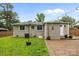 A backyard featuring a brick patio, a grass yard, and a home's exterior at 5008 Unaka Ave, Charlotte, NC 28205