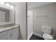 Well-lit bathroom featuring a granite vanity and a walk-in shower with subway tile at 5008 Unaka Ave, Charlotte, NC 28205