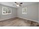 This bedroom features hardwood floors and large windows that let in plenty of natural light at 5008 Unaka Ave, Charlotte, NC 28205