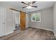 This bedroom features a sliding barn door to the ensuite bathroom and hardwood floors at 5008 Unaka Ave, Charlotte, NC 28205