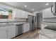 Well-lit kitchen showcases stainless steel appliances, granite countertops, tile backsplash, and wood-look flooring at 5008 Unaka Ave, Charlotte, NC 28205
