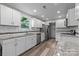 Updated kitchen with white cabinets, stainless steel appliances, granite countertops, and modern backsplash at 5008 Unaka Ave, Charlotte, NC 28205