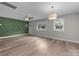 Bright, airy living room with wood-look flooring, freshly painted walls, and abundant natural light at 5008 Unaka Ave, Charlotte, NC 28205