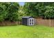 A backyard shed with grass and a wooden fence in the background at 5008 Unaka Ave, Charlotte, NC 28205
