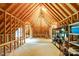 Unfinished attic with exposed wood framework and storage shelving at 517 Kingsdown Ct, Waxhaw, NC 28173