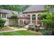 A stunning home featuring a lovely patio with outdoor seating, stone accents, and arched windows at 517 Kingsdown Ct, Waxhaw, NC 28173